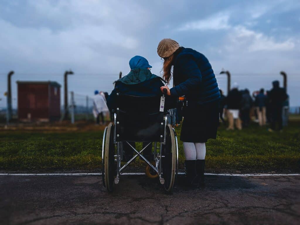 Lady living with CP is in a wheelchair at a farm with a female caregiver