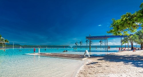 A wheelchair-friendly swimming pool nestled amidst a stunning beach in Cairns offers fun things to do for wheelchair users.