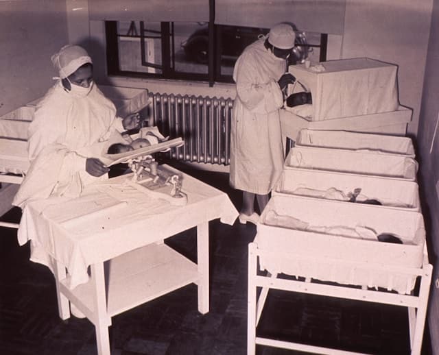 maternity ward nurses take care of a nursery of babies born after World War II - and now today, known as "baby boomers"