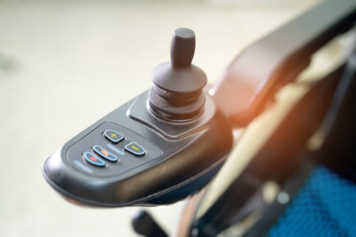 A close up of a wheelchair remote control with accidental damage coverage.
