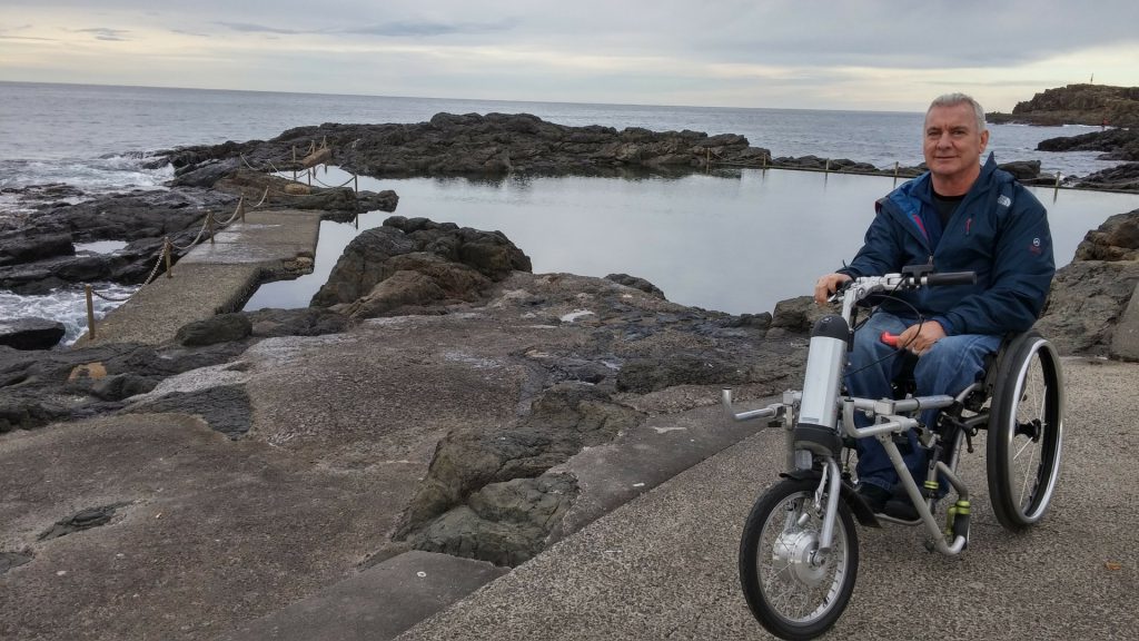 Malcolm uses hand bike power assist add on