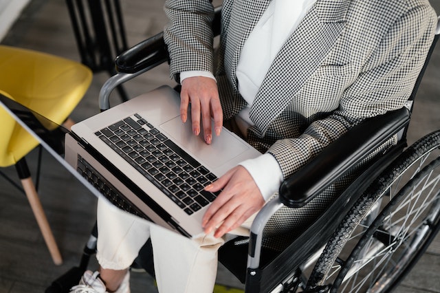 a woman applies online for taxi subsidies for wheelchair users