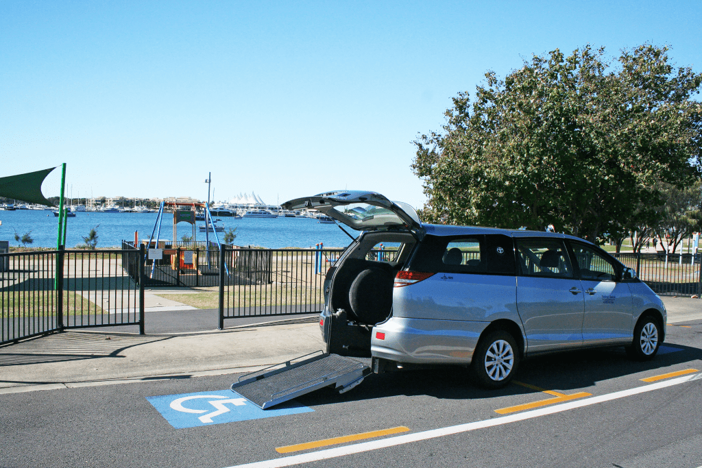 wheelchair accessible vehicle in parking spot. The driver has a disability parking permit