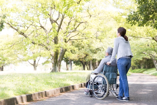 woman in wheelchair asks carer what are reasonable and necessary supports