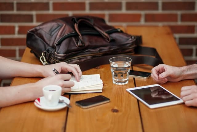 meeting at coffee shop with disability support worker. Parent is taking notes