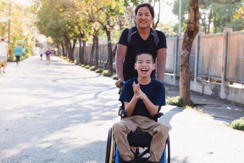 tween boy in wheelchair with his disability support worker