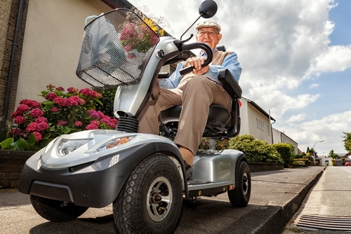 After buying a mobility scooter, this man is using it for shopping.