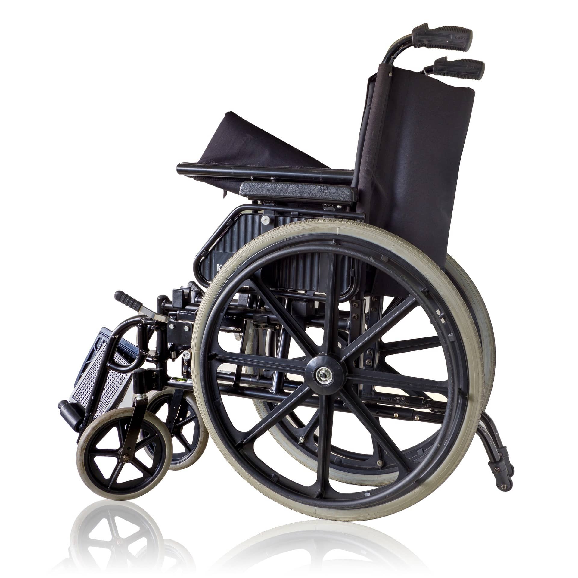 Black wheelchair in front of a white background.