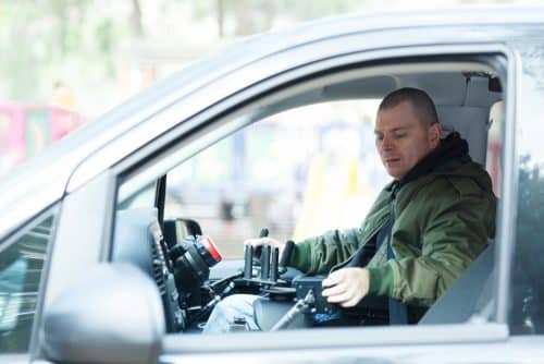 man takes disability converted vehicle for maintenance check. You should avoid driving without insurance because getting into a car accident with no insurance can lead to a hefty financial burden on you.