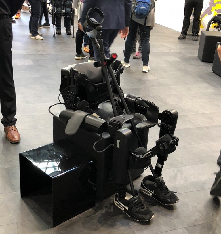An exoskeleton suit on show at an expo. The suit is mechanised, lightweight and a great development in assistive technology