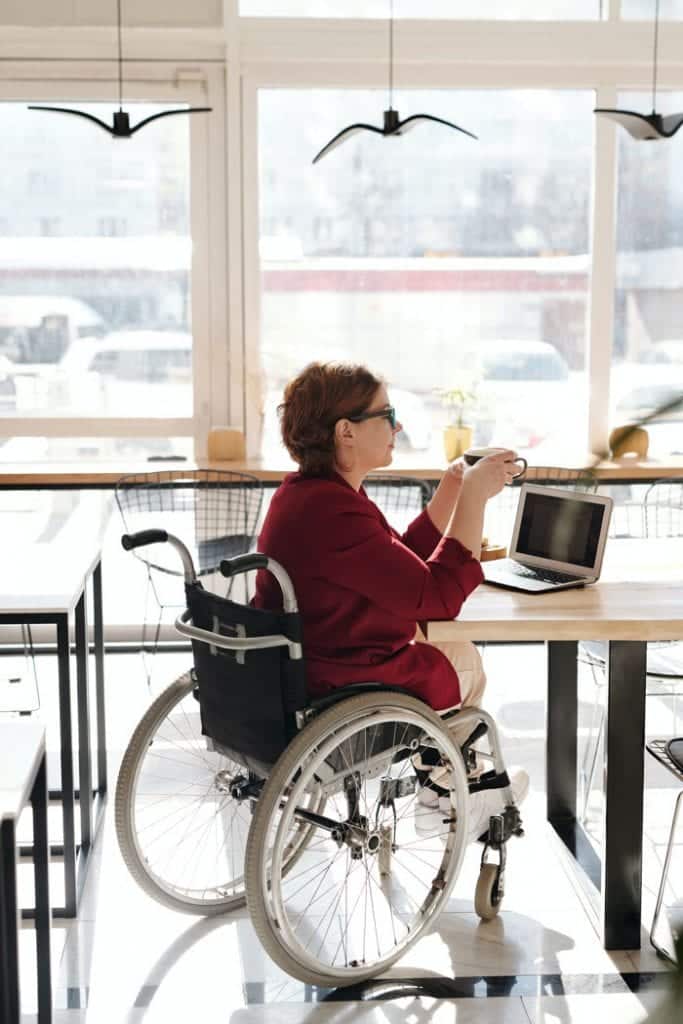 This woman with a disability equipment hire wheelchair is speaking to an NDIS support coordinator