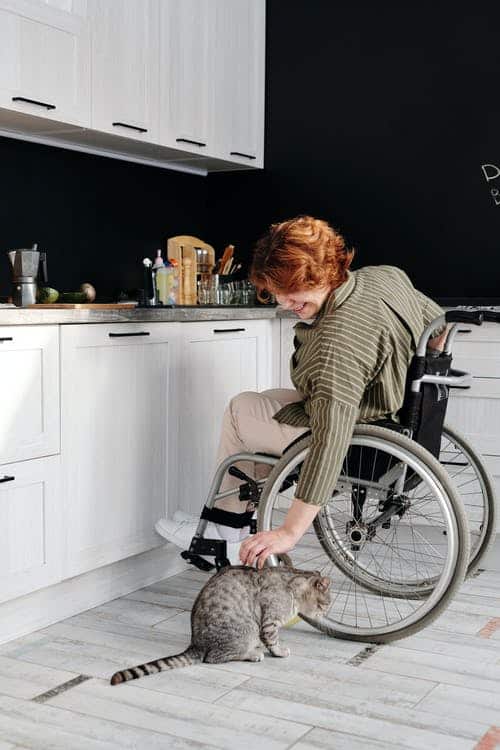 This woman is enjoying a holiday at a pet-friendly accessible holiday destination. 