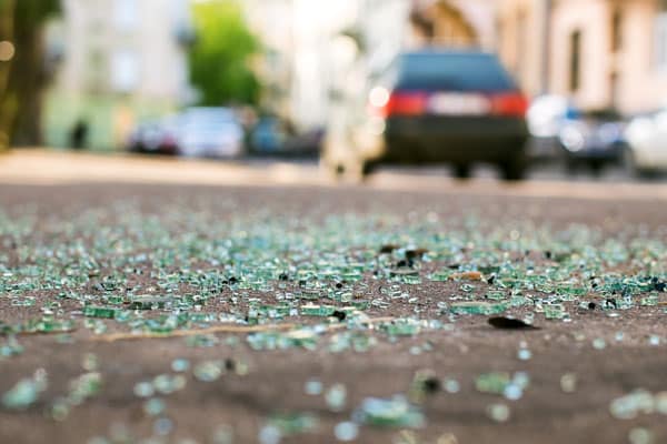 Glass all over the road after an accident. You might be shaken after a crash, so be sure to record details for your car insurance claim later