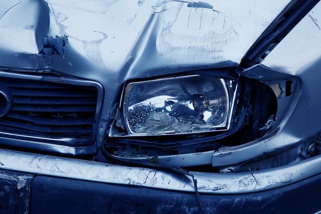 close up of a dented car headlight after an accident