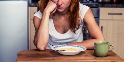 woman in front of bowl of cereal