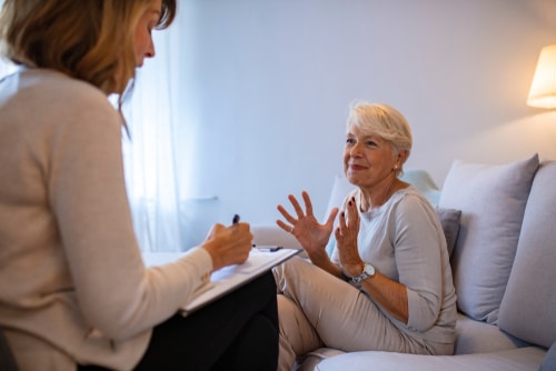 older woman talking to occupational therapist