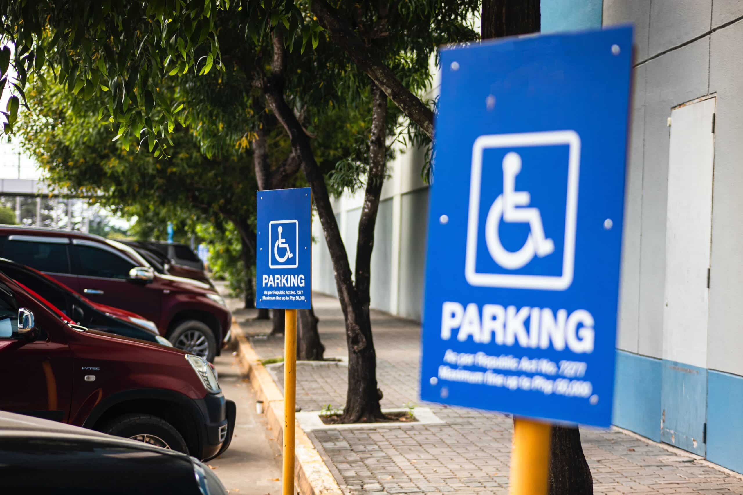 A blue sign indicating that it's a parking space only for disability parking permit holders.