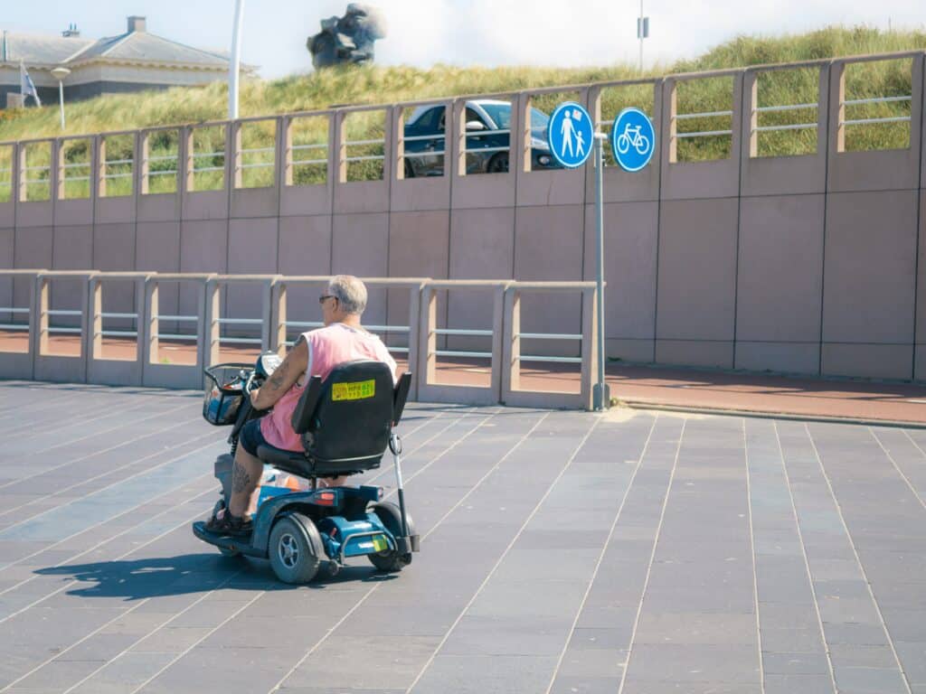 A Man Riding on a Mobility Scooter
