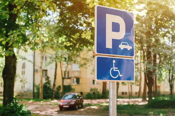 Handicap parking spot sign, reserved lot space for disabled person, selective focus