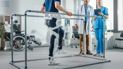 A man practices walking in an exoskeleton suit, a great development in assistive technology