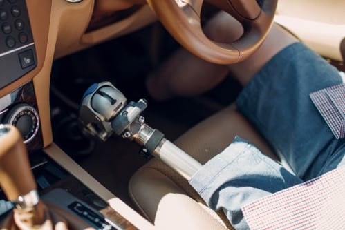 driver with a prosthetic leg takes the disability driving assessment to use driving driving aids