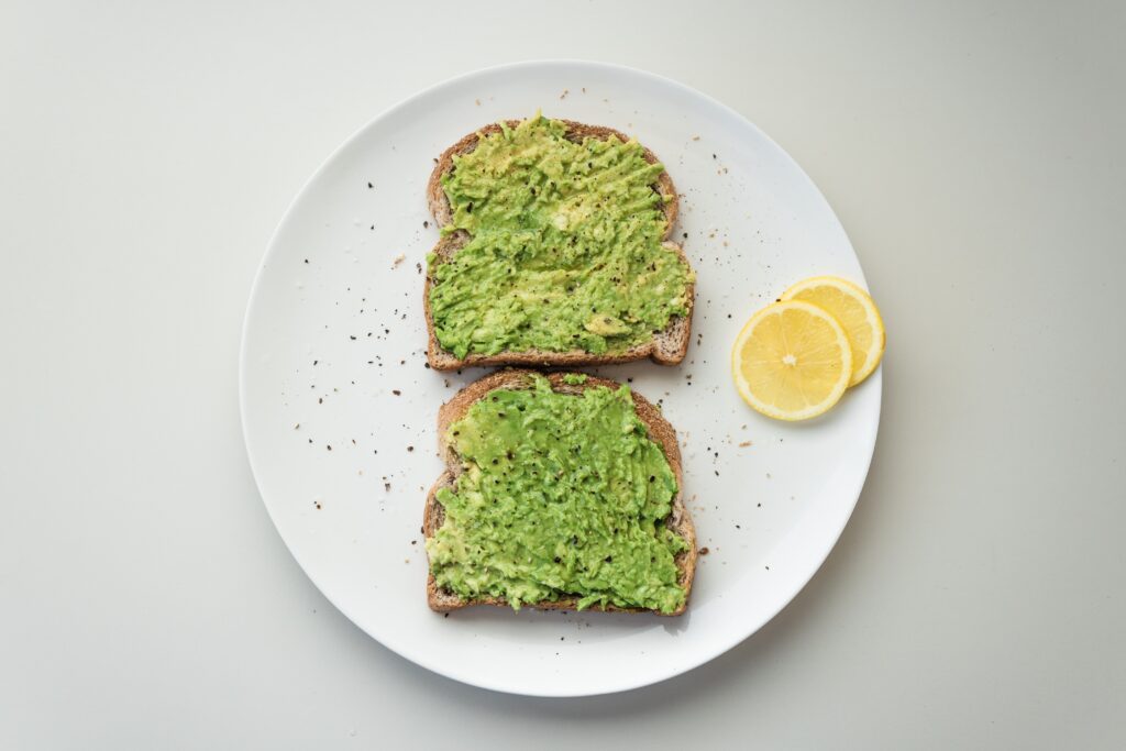 Avocado on toast with lemon slices and black pepper as pictured is an easy meal to make during depression episodes.