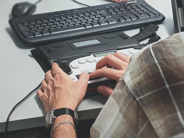 man with uses a modified computer keyboard 