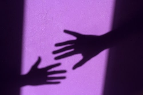 purple shabby wall with palm shadows The National Redress Scheme offers compensation for child sexual abuse faced by people living with disability in australia