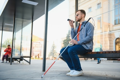 a man with vision impairment uses the listening smartphone accessibility feature to check his daily emails