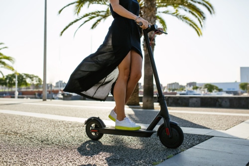 woman rides an e-scooter as part of the NSW electric scooter trial