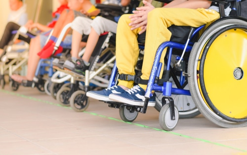 Four children with disabilities sitting in wheelchairs. They may want to play adaptive sports like boccia