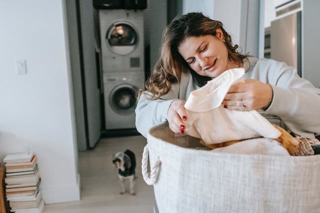 Woman with limited mobility checks if the vinegar has helped loosen and remove pet hair on her clothing