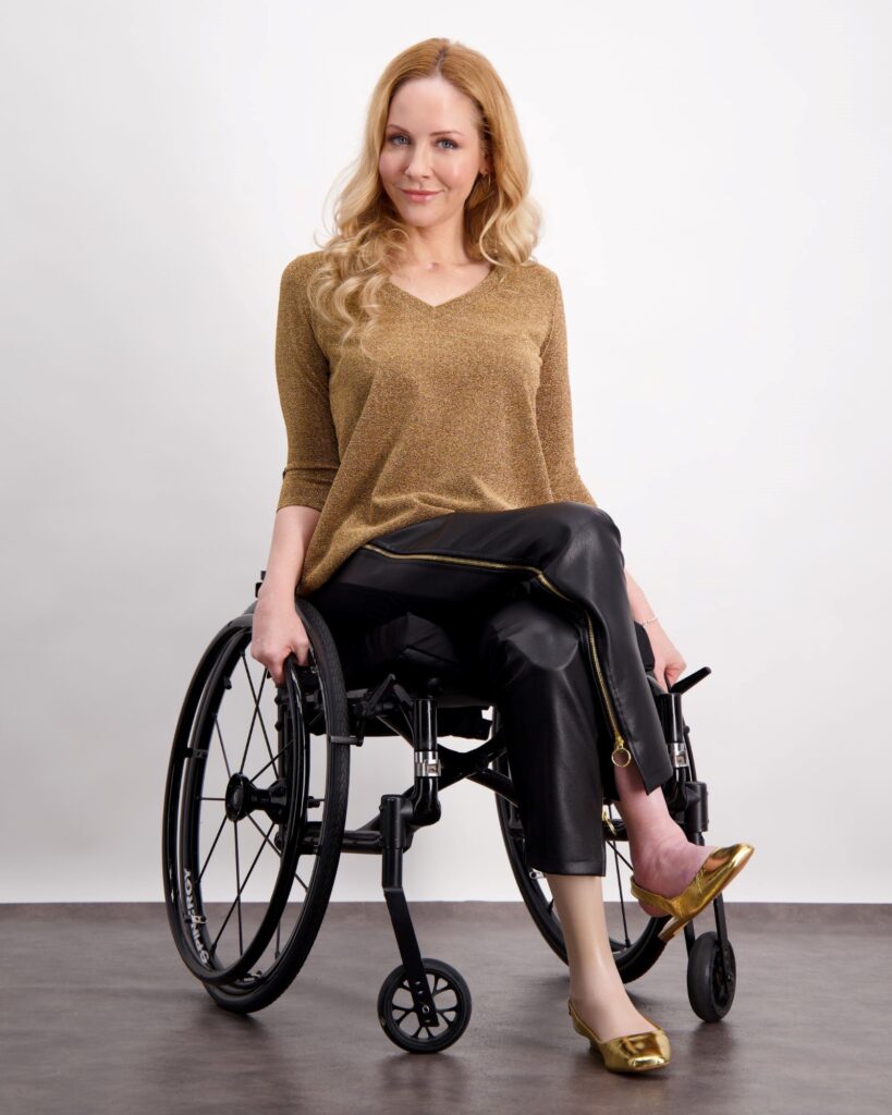 A model seated in a wheelchair showcasing Christina Stephens accessible fashion
