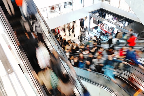 Busy shopping centre seen through the lens of a PTSD sufferer feeling overwhelm from sensory overload 