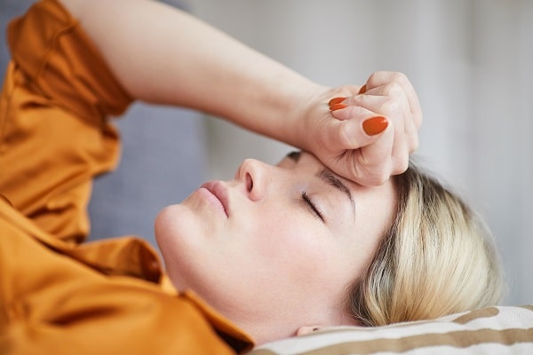 Close-up of exhausted young woman with caregiver burnout