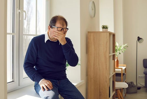 A photo of a man stressing out over life problems. He may be in need of respite care