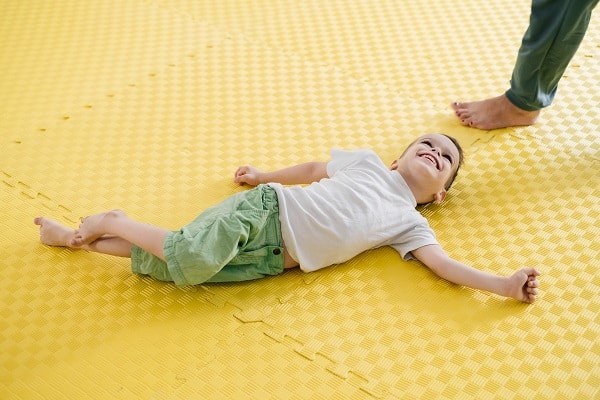 Boy with the motor disability cerebral palsy smiling at a rehabilitation and inclusion kindergarten