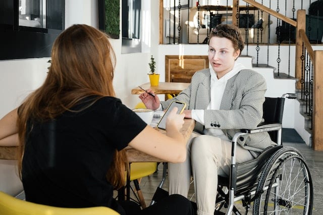 a woman has a job interview and has used her mobility allowance to get there on an accessible taxi