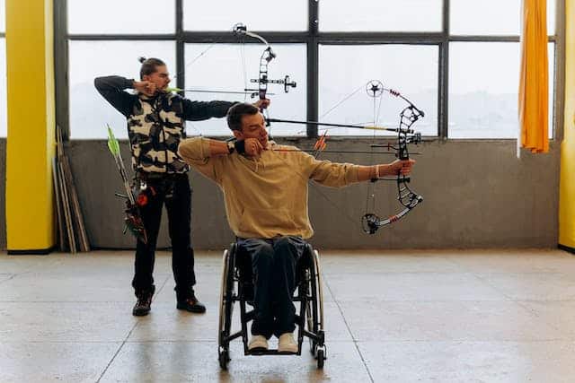 A man participating in disability inclusive archery 