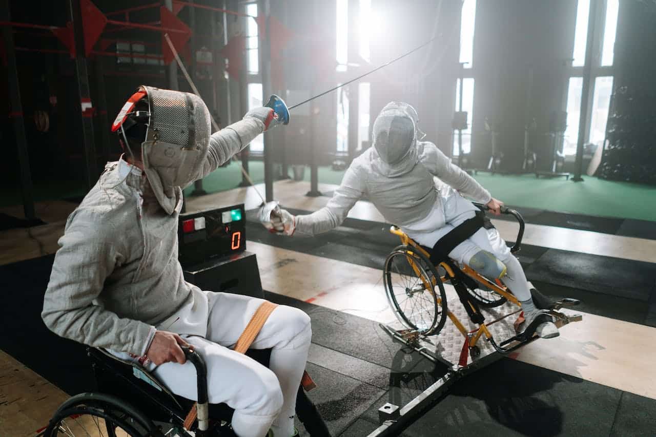 Two fencing champions play disability adapted inclusive fencing