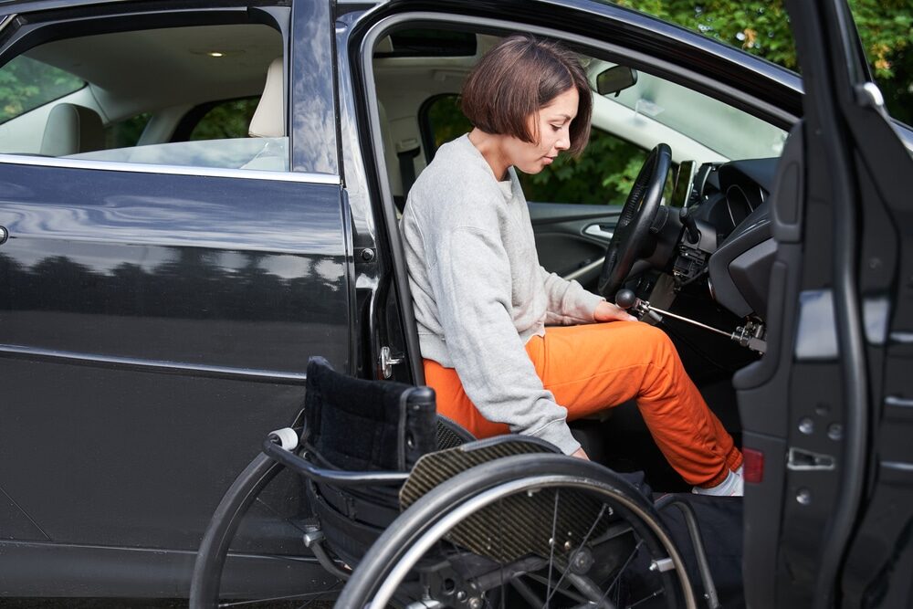 A woman drives a vehicle with modifications for driving with disability and has them protected in case of theft or damage with modified car insurance