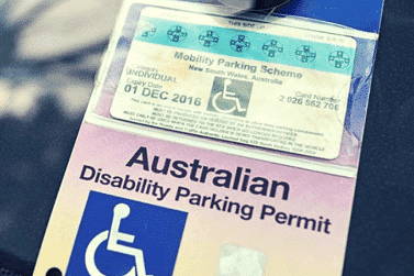 Image of an Australian disability parking permit with a blue and white design.