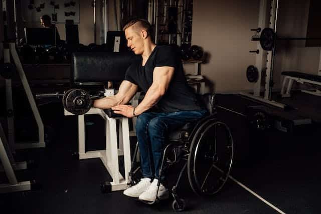 A man with limited mobility does weightlifting to work on developing and maintaining his core strength 