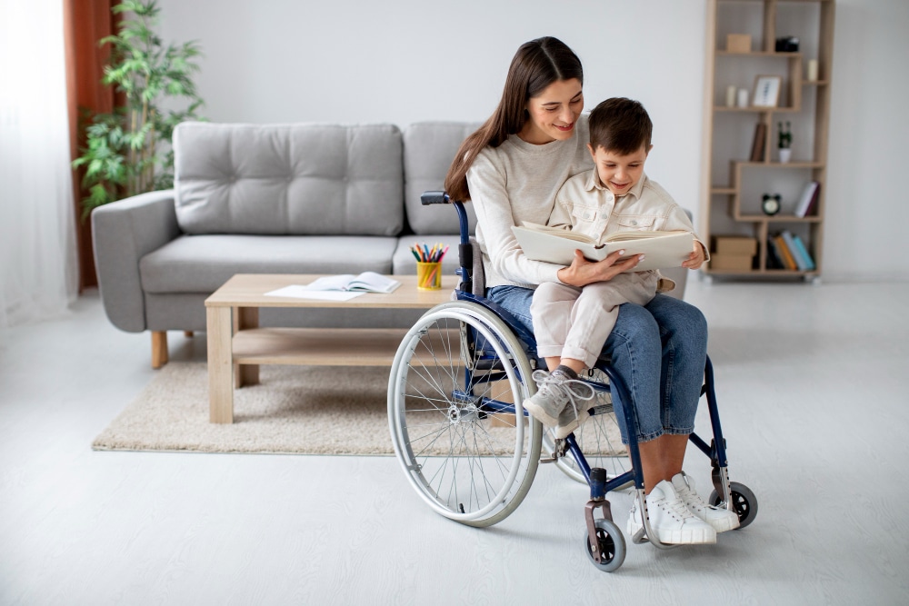 A woman in a wheelchair enjoying a moment of connection with her son as she reads a book to him.