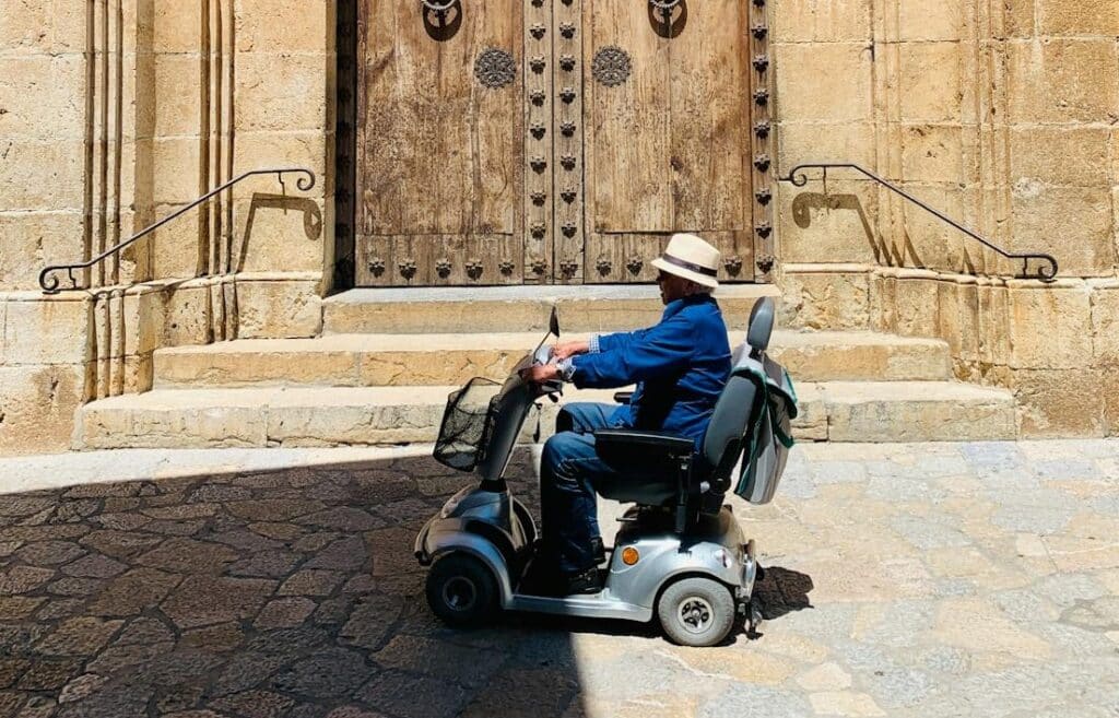 A man rides his mobility scooter home after it starts beeping