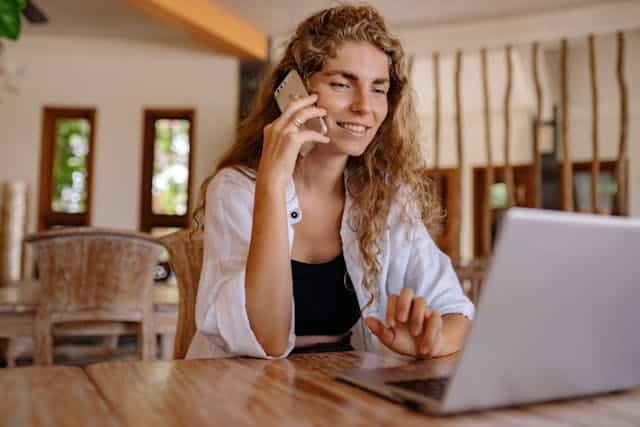 A woman talking on the phone to her mobility scooter manufacturer to see why it's beeping