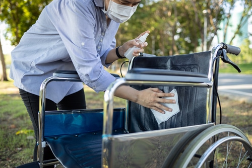 An image of someone cleaning the seat of a piece of mobility equipment