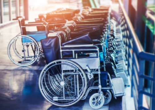 A line of wheelchairs arranged in a hallway to celebrate World Wheelchair Day.