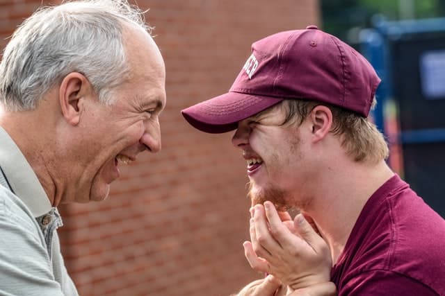 A man is talking to his son who he is fulltime carer for and as a result, receives the carer's payment